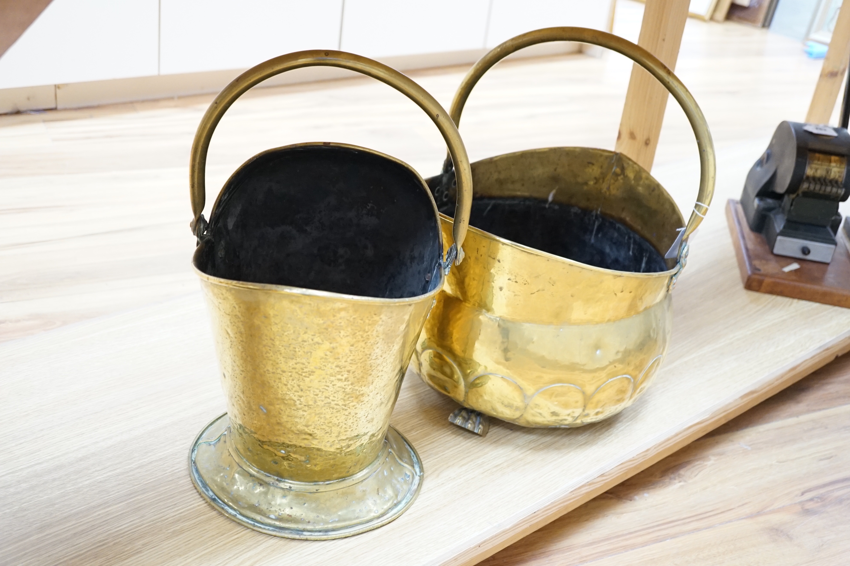 A brass helmet coal scuttle and another